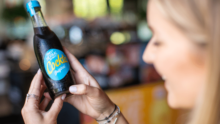 Girl holding Cockta bottle